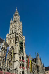 Fototapeta na wymiar The clock tower of the new City Hall (Rathaus) in Marienplatz is a famous building in Gothic architecture - Munich, Bavaria, Germany, Europe