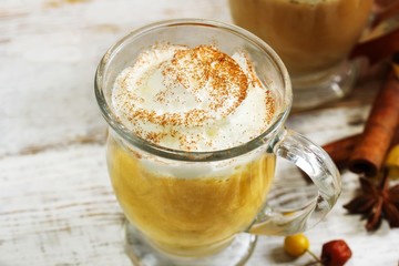 Homemade Pumpkin spice Latte on rustic white wooden background