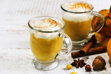 Homemade Pumpkin spice Latte on rustic white wooden background