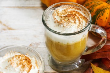 Homemade Pumpkin spice Latte on rustic white wooden background