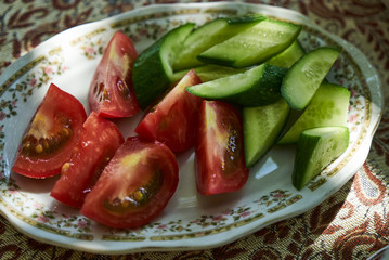 sliced fresh vegetable salad with tomatoes and cucumber, close-up