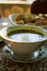 Traditional Azerbaijan dushbere soup with meat dumplings and fresh vegetable sliced tomatoes, cucumbers and pita bread