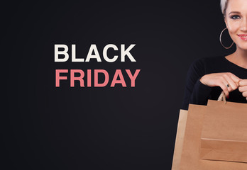 Shopping woman holding bags isolated on blue background in black friday holiday. Summer shopping...