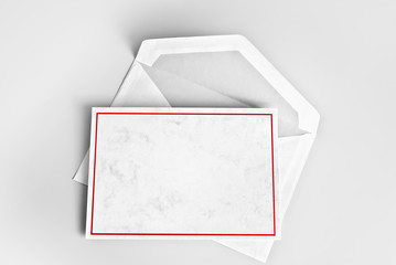 Blank greeting or thank you card with red frame over envelope