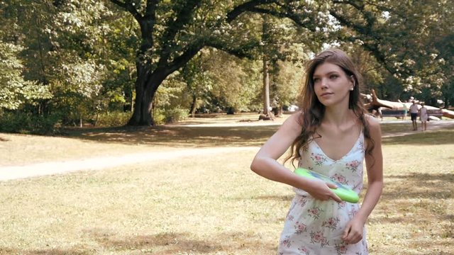 Slow Motion Girl Throwing Frisbee in a Park