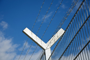 Fence with barbwire as close up