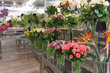 Fototapeta na wymiar Assortment of beautiful flowers in shop. Florist's workplace