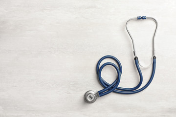 Stethoscope and space for text on light background. Medical object