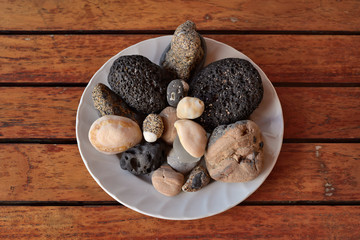 still life of stones on the background of parallel wooden planks, top view