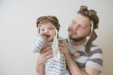 father and son play dressed as a pilot