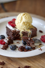 Chocolate brownie with a scoop of ice cream on top 