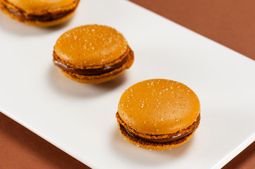 Salted caramel macarons on the white plate