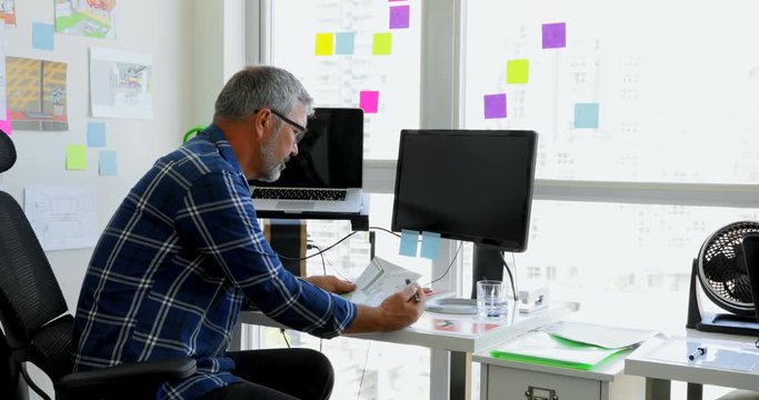Man working on the desk at home 4k