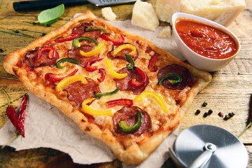 Homemade pizza with salami and pepper