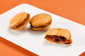 Salted caramel macarons on the white plate