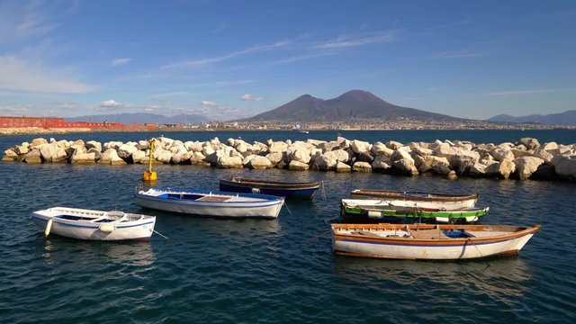 Colorful rowboats moored in the Gulf of Naples with Mount Vesuvius in the background, Naples, Italy
