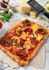 Homemade pizza with salami and pepper
