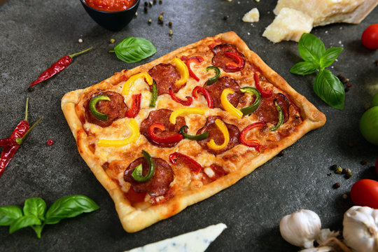 Homemade pizza with salami and pepper