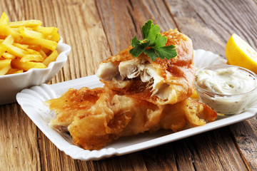 traditional British fish and chips consisting of fried fish, potato chips and mayonnaise