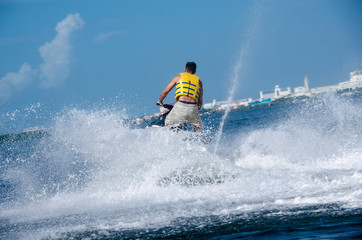 Naklejka premium Man on a waverunner on the caribbean sea