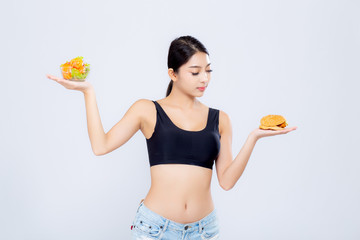 Beautiful asian woman slim shape with diet choosing fresh salad vegetable and hamburger isolated on white background, food healthy with control for weight loss, nutrition and lifestyle concept.