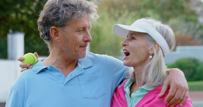 Senior couple talking in tennis court 4k