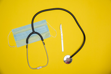 Precission sharp knife with sterile mouth face mask and stethoscope. Heathcare diagnosis equipment