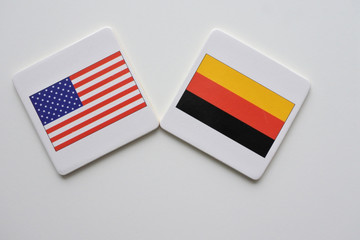 US and Germany flags on white background