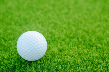 Golf ball on green grass ready to play at golf course. with copy space