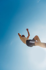 Caucasian man jump high in the air while doing parkour