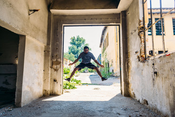 Man exercising jumping in abandoned factory