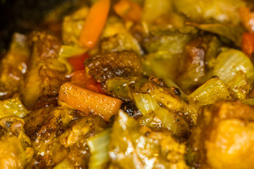 Roast meat, onions, carrots and spices, boiling in oil