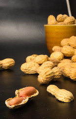 Peanuts in shell on dark background, close up
