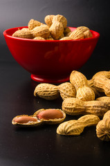 Peanuts in shell on dark background, close up