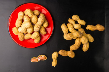 Peanuts in shell on dark background, close up