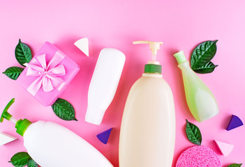 Cosmetic packaging plastic bottle shampoo cream shower gel milk green leaves sponge box gift bow Natural organic product skin and hair care shopping Top view pink flat lay background.