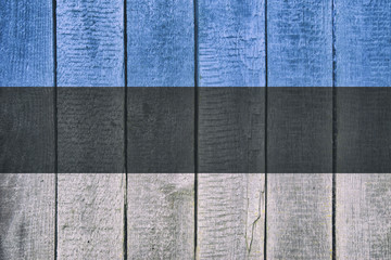 Old  wooden table texture background top view  with a National Flag of Estonia. Estonian Flags image.