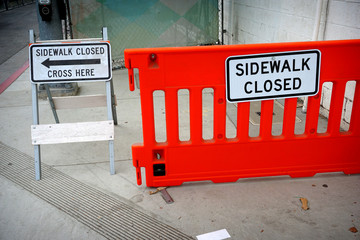 sidewalk closed sign with barricades