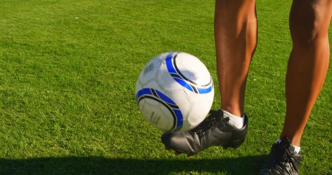 Soccer player tossing the ball between his legs 4k