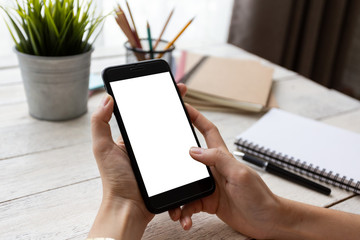 hand woman using a telephone, empty screen smart phone and computer on wooden table In home office. with clipping path