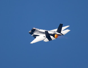 Extremely  close tail view of an F-35 Lightning II  in a high G turn, with afterburner on 