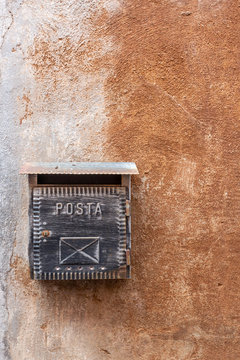 Old Italian mailbox on wall in Tuscania, Italy