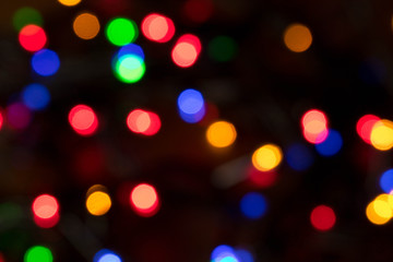 Blurred background of burning Christmas lights. Christmas and New year holidays concept