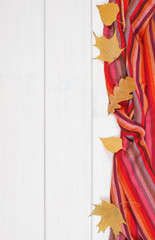 Womanly shawl and leaves on boards, clothing for autumn or winter, place for inscription