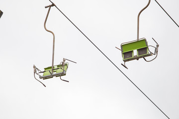 Sky and ski lift. Green chair and big cables. Travel photo 2018.