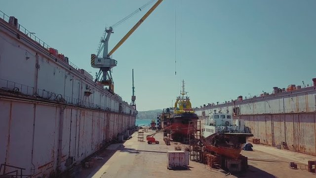 Shipyard. Three Ships in Repair in a Floating Dock. Overhaul and Modernization of Ships