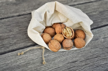 Sack of walnuts on wooden rustic floor