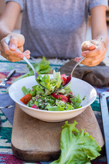 Fresh summer salad with salad leaves, tomatoes, pumpkin seeds.