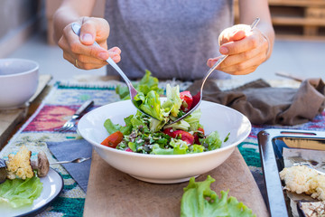 Fresh summer salad with salad leaves, tomatoes, pumpkin seeds.