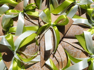 Handmade paper favors with green and white bow